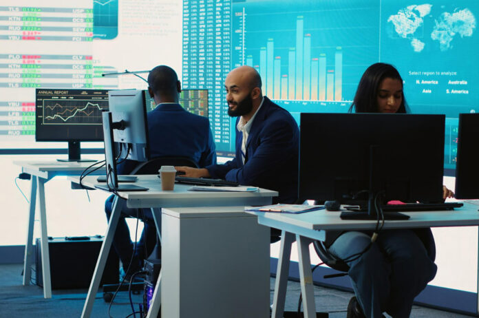 Smiling business people working and using tablet in outdoor cafe
